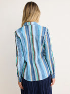 Crinkled cotton shirt with varied vertical stripes in shades of blue, green, orange, black, and white. Back view.
