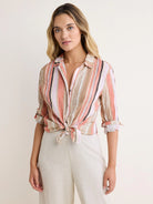 Vertical striped shirt in beige, coral, pink, and black. Rolled 3/4 sleeves, front tie knot.