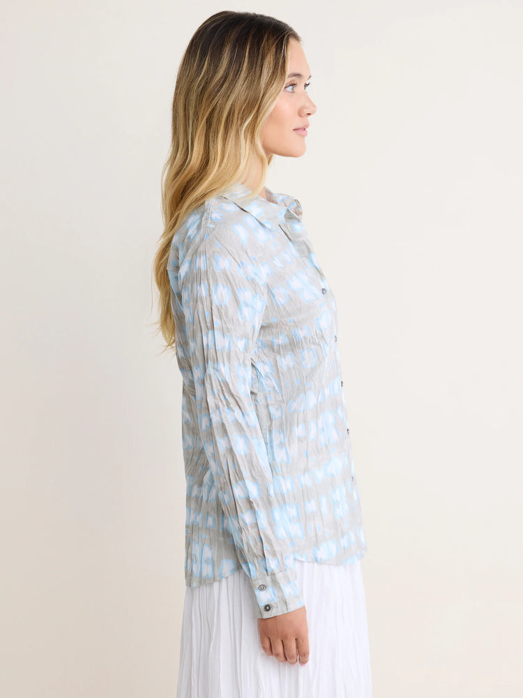 Light gray crinkled cotton shirt with light blue shibori patterns. Button-up, long sleeves.