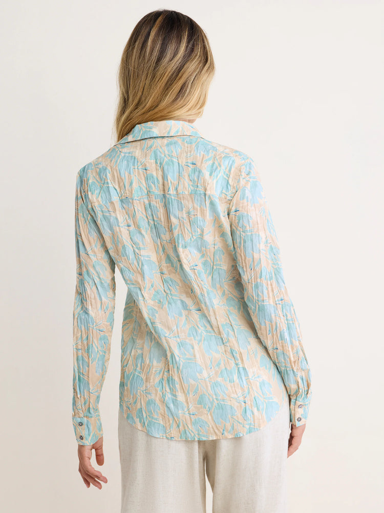 Long-sleeve crinkled shirt, light tan with pale blue abstract floral pattern.