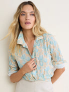 Muted blue floral pattern on beige crinkled cotton button-down shirt.