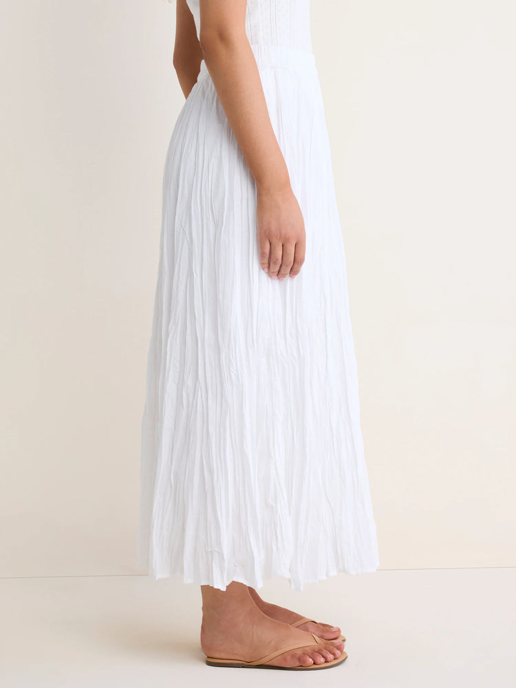 Long white cotton crinkle skirt with a flowing silhouette.