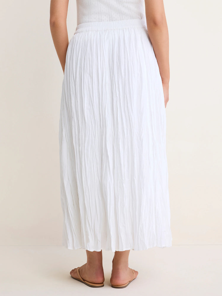 White, ankle-length crinkle skirt with an elastic waist, featuring visible vertical folds.
