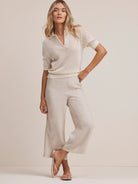 Light beige wide-leg cropped pants with a visible linen blend texture.