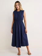 Navy sleeveless dress with gathered round neck, elasticized waist, and A-line midi skirt.