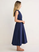 Navy blue sleeveless poplin dress with a cinched waist and flared midi skirt.