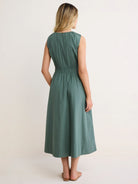 Sage green sleeveless midi dress, back view. Features gathered neckline and shirred elastic waist with a flowing skirt.