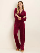 Dark red velour half-zip pullover with ribbed cuffs. Matching drawstring wide-leg pants.