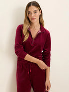 Burgundy velour half-zip pullover with a stand collar and metallic zipper.