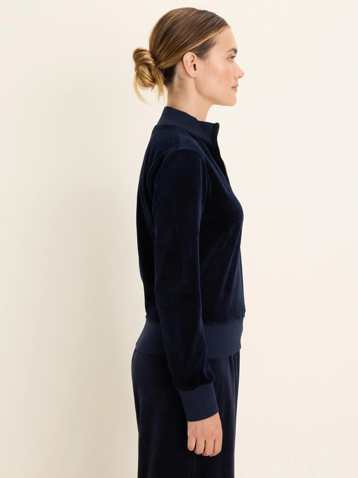 Dark blue velour half-zip pullover with a stand-up collar and long sleeves.