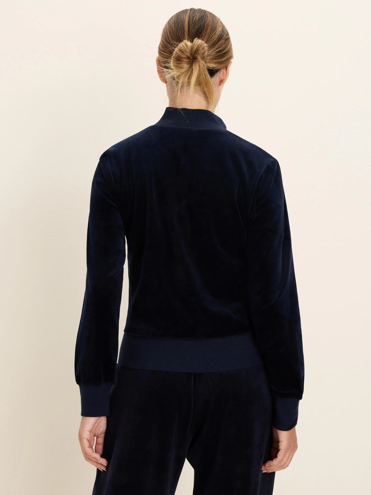 Navy velour half-zip pullover with ribbed cuffs and hem, worn by a woman from the back, with matching pants.