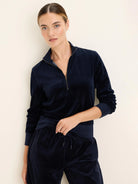 Navy velour half-zip pullover with a gold-tone zipper, stand collar, and ribbed cuffs and hem.