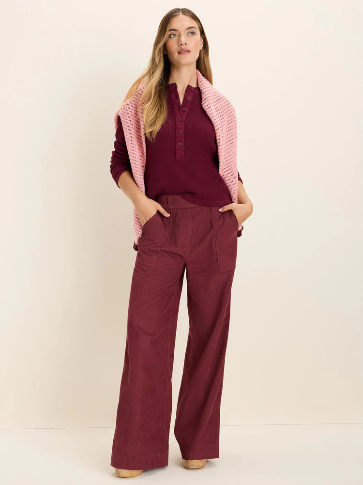 Burgundy long-sleeve ribbed henley top with a 4-button placket.