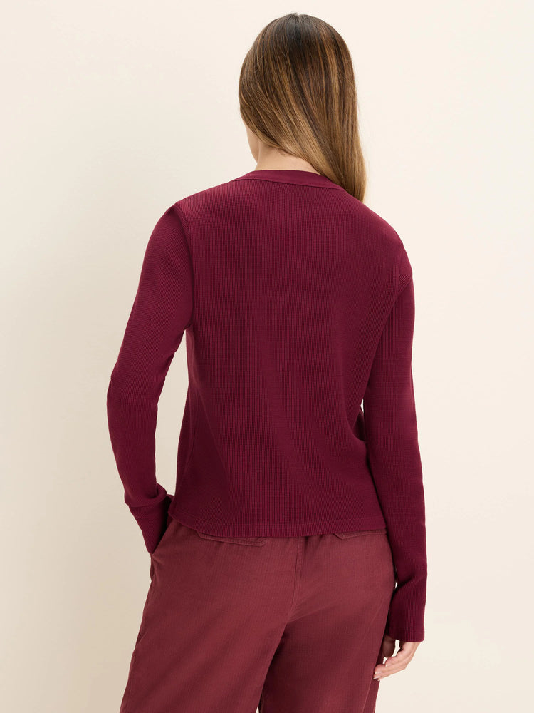 Maroon long-sleeve waffle-knit top on a model, back view.