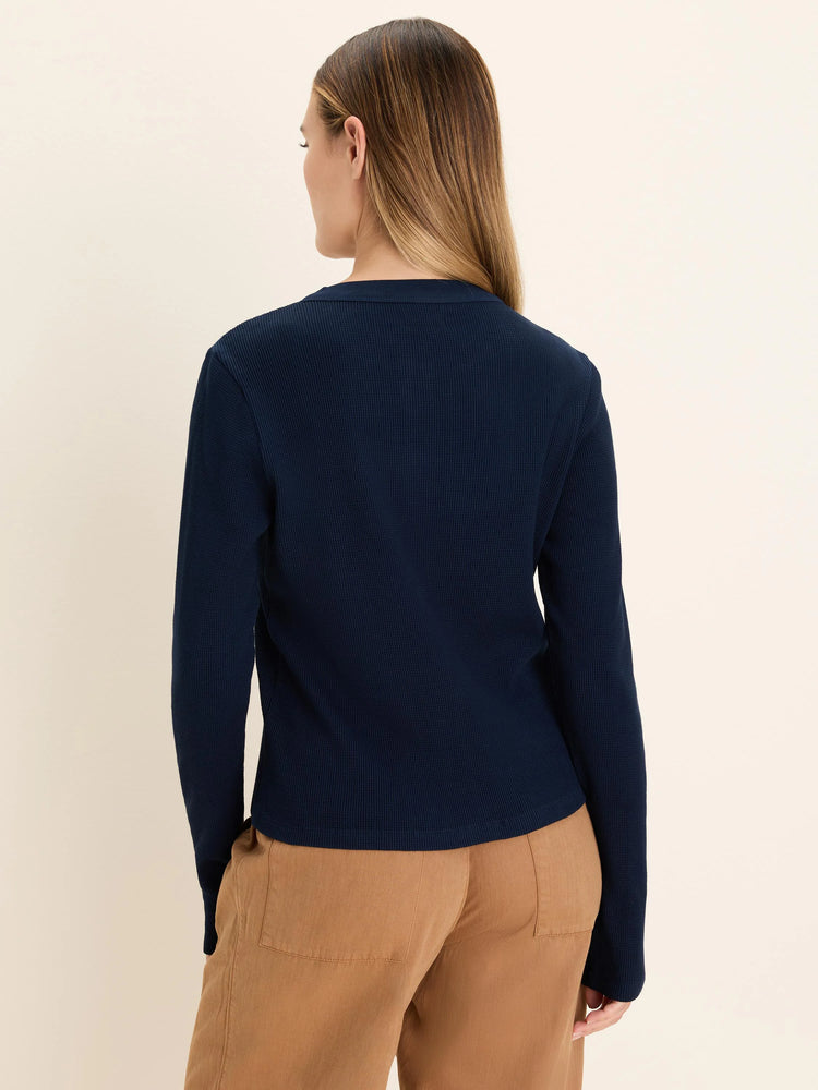 Navy thermal long-sleeve top with waffle knit texture and ribbed collar.