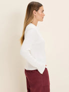 White long-sleeve thermal Henley top with a waffle knit texture.