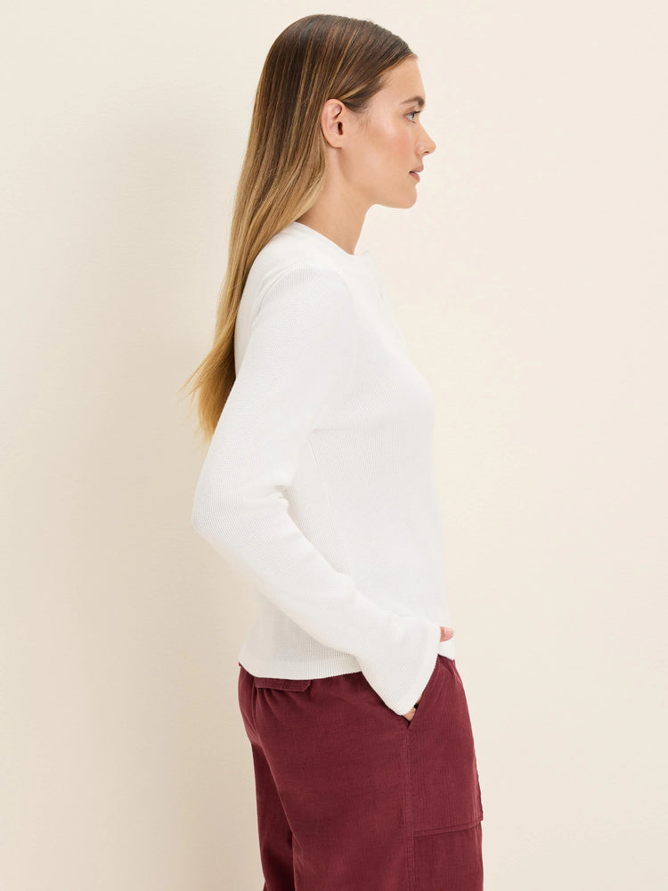 White long-sleeve thermal Henley top with a waffle knit texture.