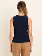Back view of a navy ribbed tank top with delicate lace trim on the neckline.