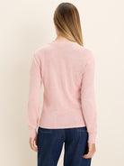 A pink, long-sleeved knit sweater, shown from the back on a model.