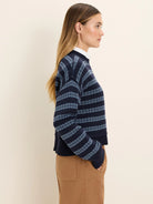 Navy blue cotton jacquard sweater with light blue patterned horizontal stripes.