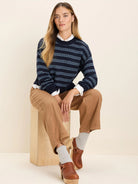 Navy sweater with light blue jacquard patterned horizontal stripes.