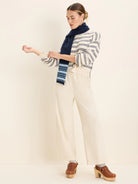Cream jacquard sweater with navy geometric striped pattern. Features ribbed cuffs and hem.