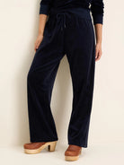 Navy velour wide-leg pants with an elastic waist and tied drawstring.