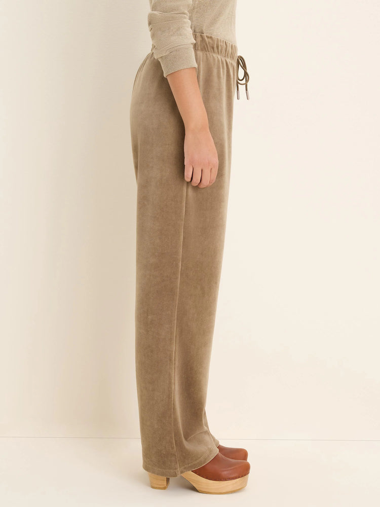 Side view of taupe velour pants. Features an elastic drawstring waist and a relaxed straight leg.