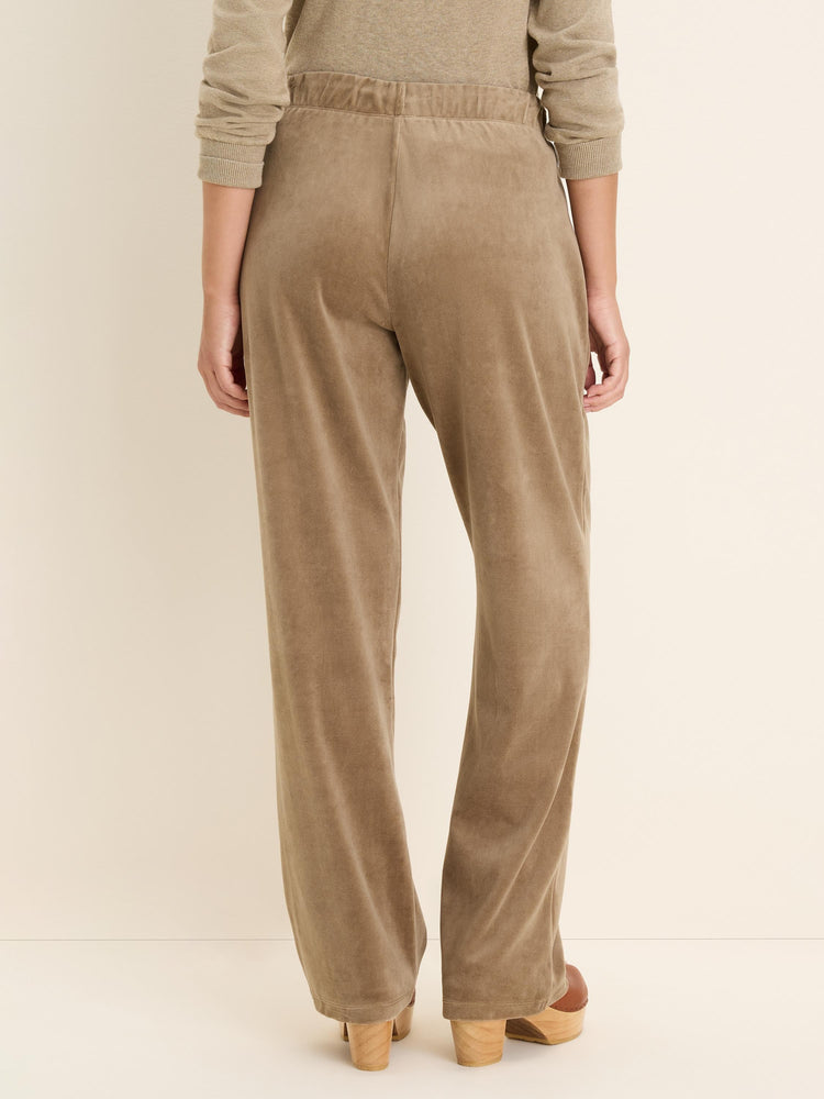 Taupe velour pants with elasticated waist and straight leg. Back view.
