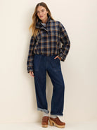 Dark blue, brown, and white plaid cropped jacket with a high collar and elasticized hem.