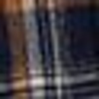 Blurry mix of dark blue, brown, & orange with streaky white reflections, like a wet, glossy surface.