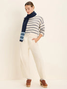Cream, wide-leg, relaxed ankle pants with a gathered, high waist.