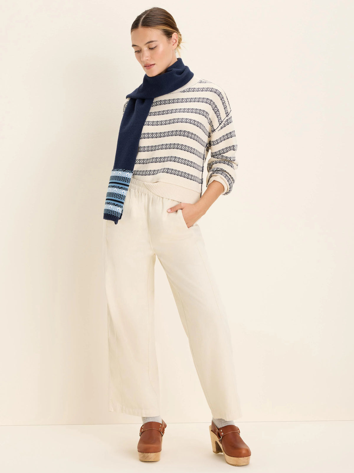 Cream, wide-leg, relaxed ankle pants with a gathered, high waist.