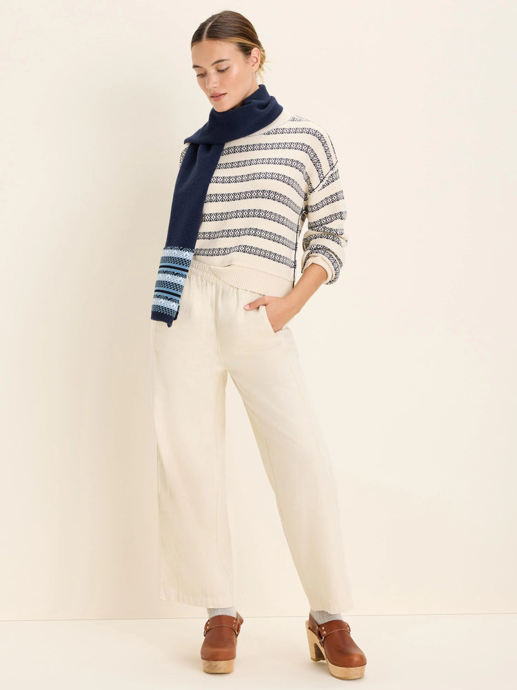 Cream, wide-leg, relaxed ankle pants with a gathered, high waist.