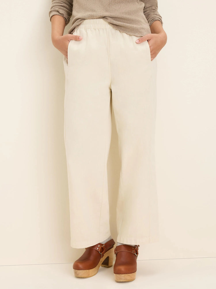 Off-white wide-leg ankle pants with an elasticized waist and side pockets.