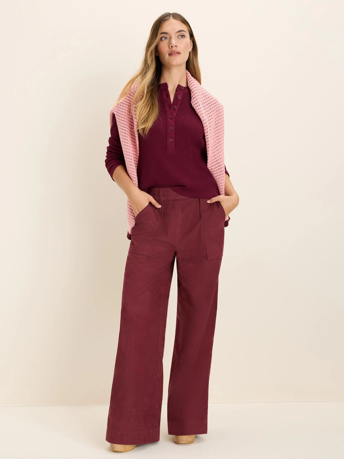 Dark red baby corduroy pants, wide-leg cut with large front patch pockets.