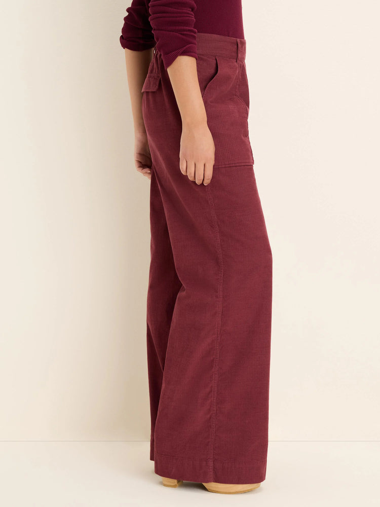 Burgundy wide-leg baby corduroy pants with front slash pockets and a thigh cargo pocket.