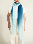Dip-dye cashmere and silk scarf; ombre design transitioning from light teal to dark teal; fringed edges.
