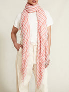 Pink and coral striped fringed scarf.  Diagonal stripes on a lightweight fabric with frayed edges.