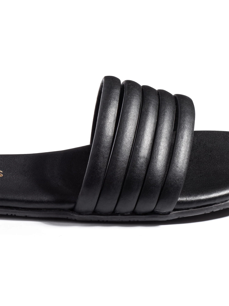 Black slide sandal with five parallel textured straps across the footbed.  Flat sole.