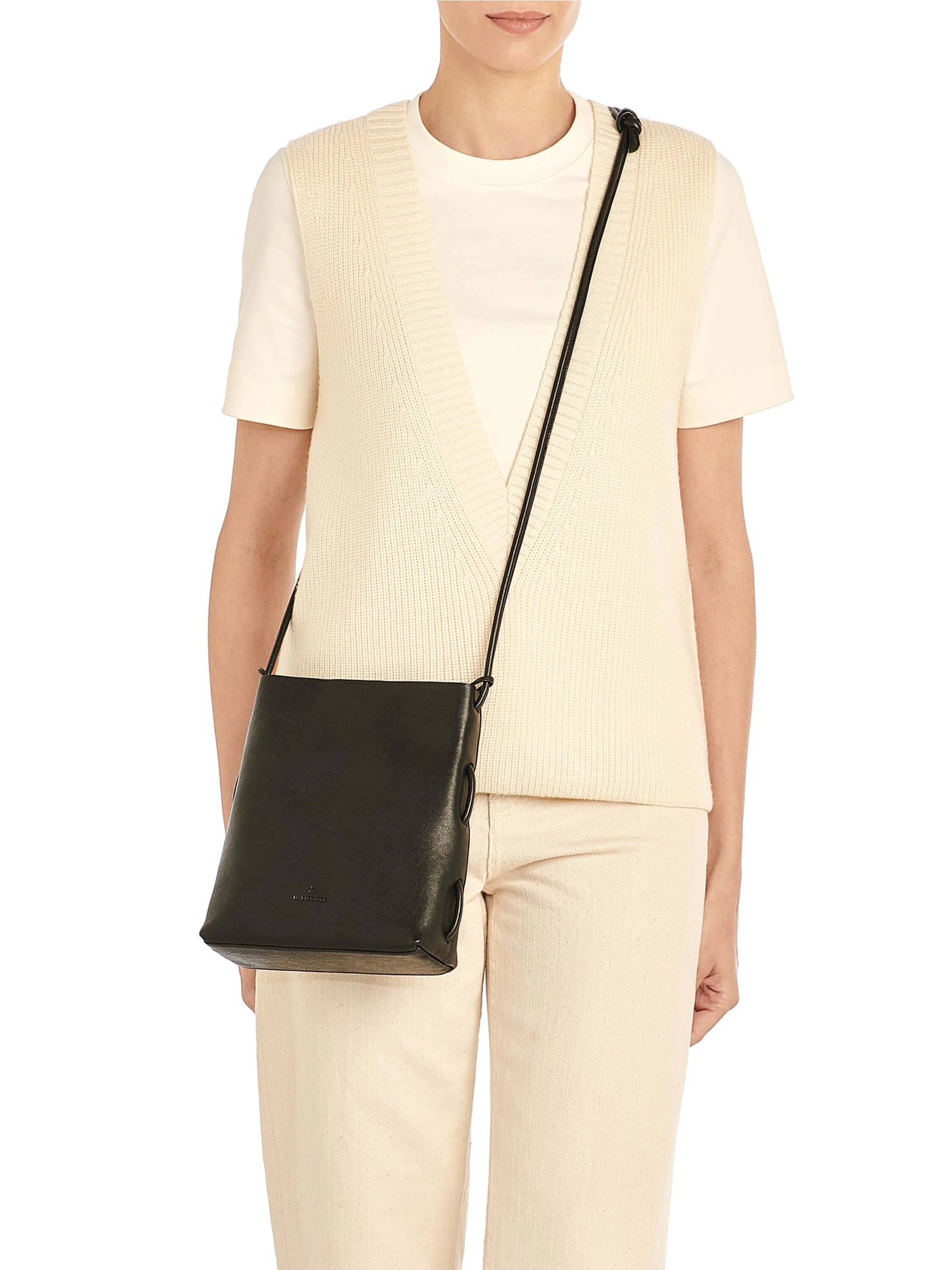 Black leather cross-body bag with a thin black strap threaded through two loops on each side.