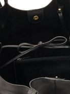 Black leather tote bag with gold-toned hardware; interior features a small zipped pocket and drawstring closure.