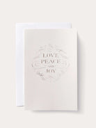 Off-white card with a light brown, decorative border and the words "LOVE PEACE AND JOY" in a serif font.  Includes a...