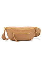 Tan, curved leather crossbody bag with gold zippers & a front pocket.