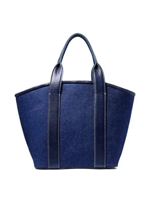 Dark blue linen top handle bag with navy leather handles and vertical trim.