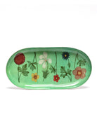 Oval light green tray with a pattern of various red, yellow, white, blue, and brownish-pink flowers.