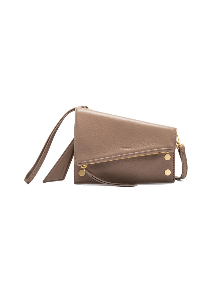 Taupe pebbled leather handbag with a diagonal gold zipper, two round gold studs on front, and a matching strap.