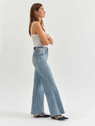 Light wash, high-waisted wide-leg jeans shown on a model.  Raw hem.