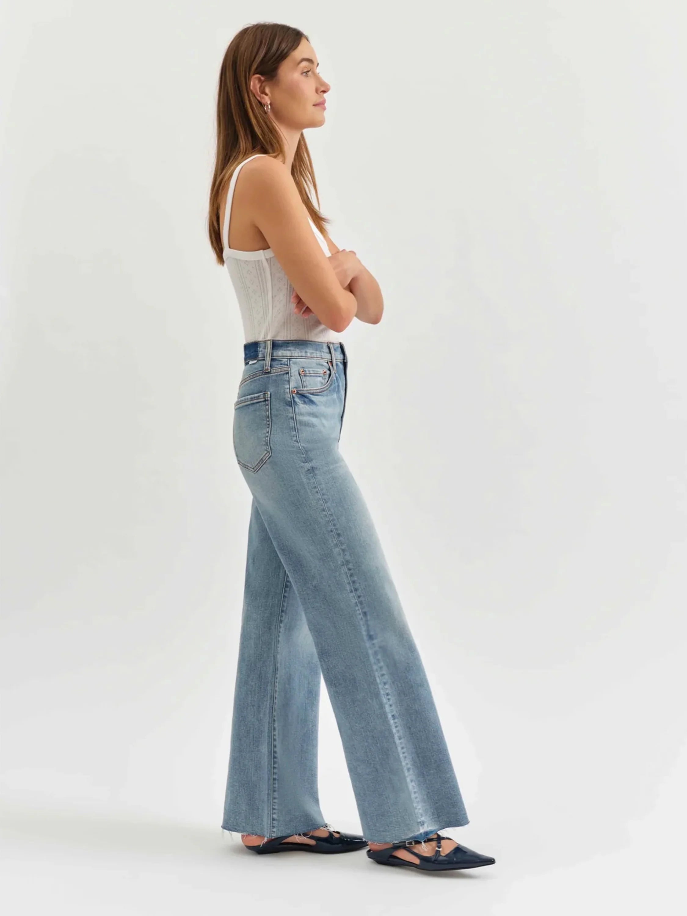 Light wash, high-waisted wide-leg jeans shown on a model.  Raw hem.
