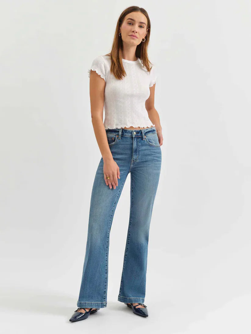 Medium blue mid-rise flare jeans, fitted through the thigh and flaring from the knee to a wide hem.